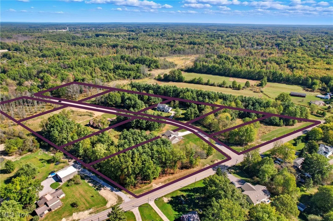 Aerial view of property's location with a forest and property parcel outlined