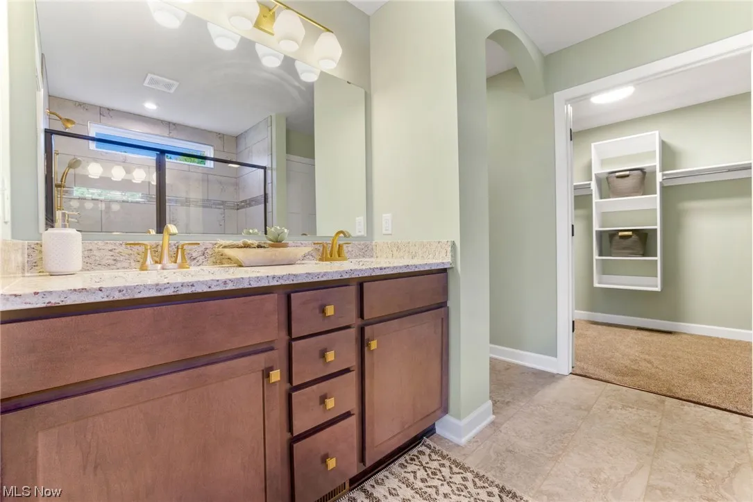 Bathroom with tile floors and dual bowl vanity