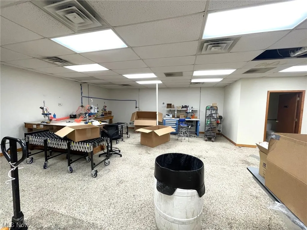 Miscellaneous room with light carpet and a paneled ceiling