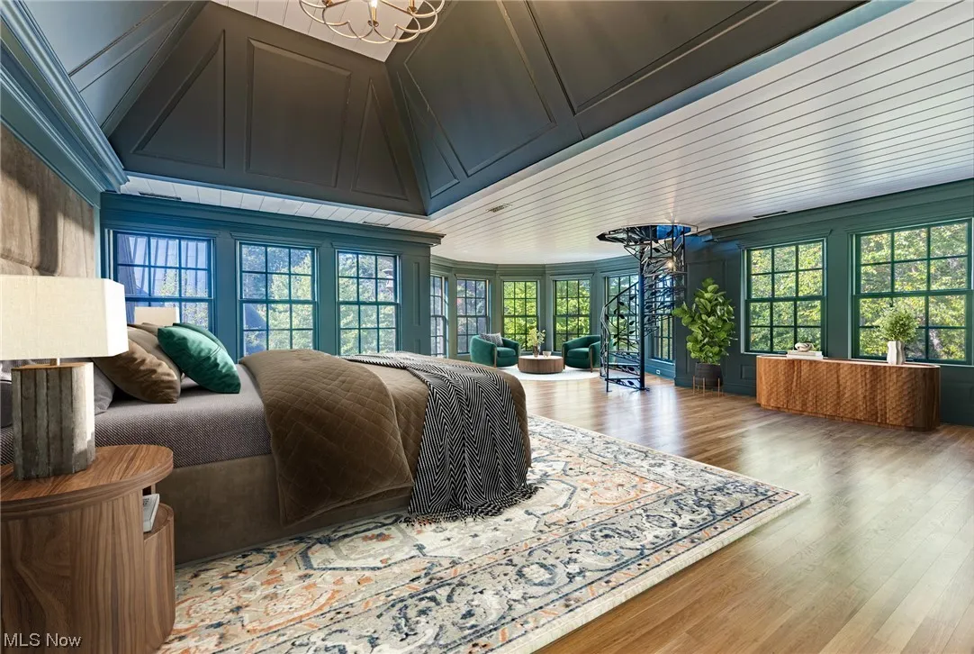 Hardwood floored bedroom with a chandelier