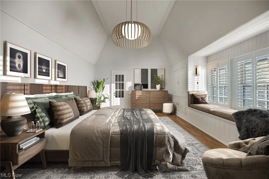 Bedroom featuring wood-type flooring and vaulted ceiling