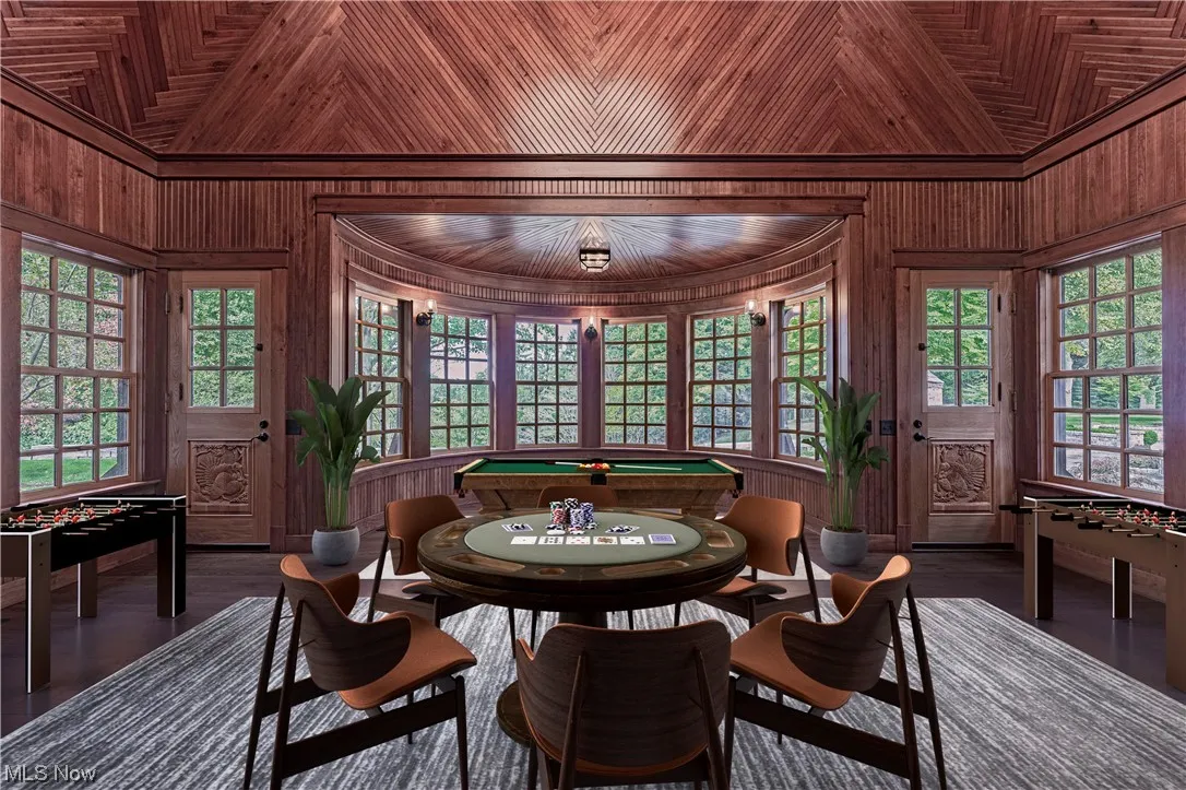 Dining room featuring wood ceiling, wooden walls, and billiards