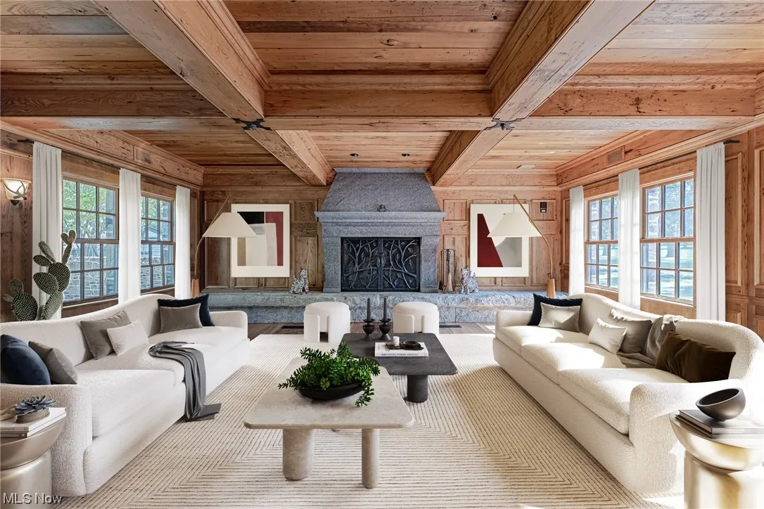 Living room featuring wood ceiling, wooden walls, a premium fireplace, and beam ceiling