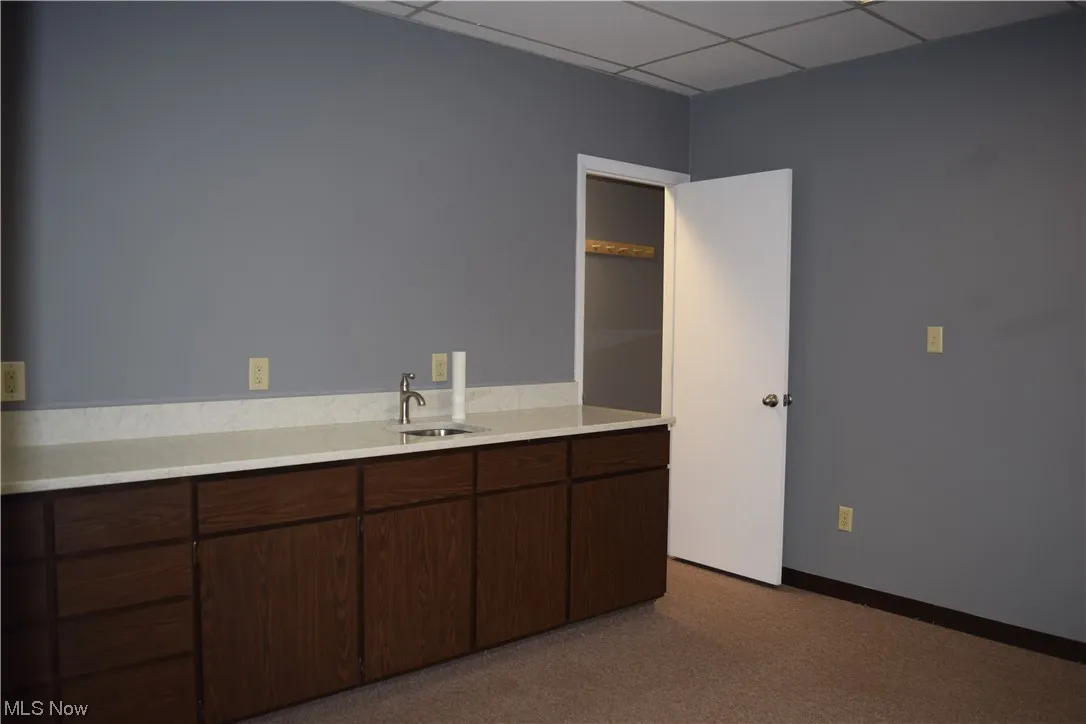 Bathroom featuring a paneled ceiling and vanity