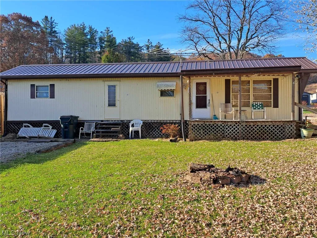 Front of Home with Covered Deck and Firepit