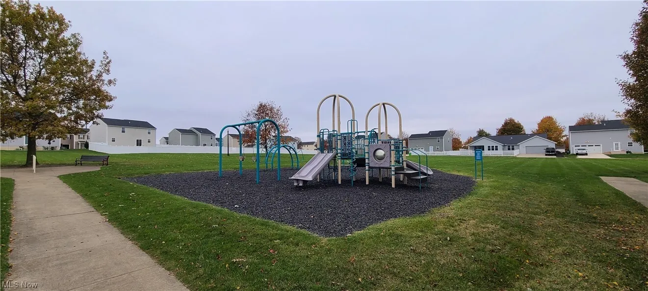 View of jungle gym featuring a lawn