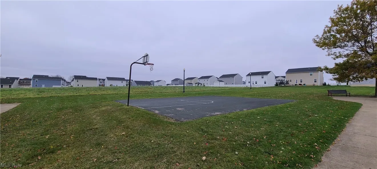 View of basketball court featuring a yard