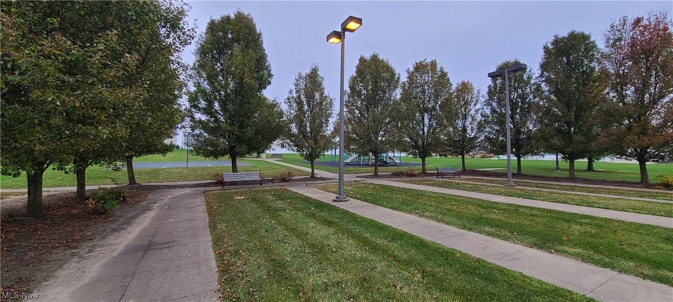 View of property's community with a yard