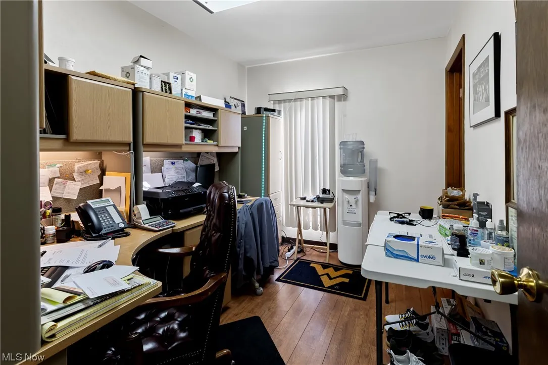office with dark hardwood / wood-style floors