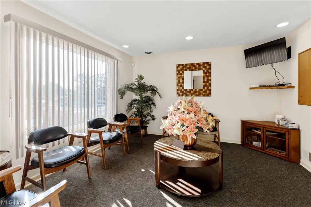 Reception room featuring dark carpet