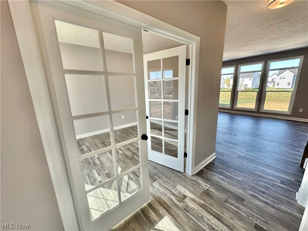 Hall featuring dark hardwood / wood-style floors and french doors