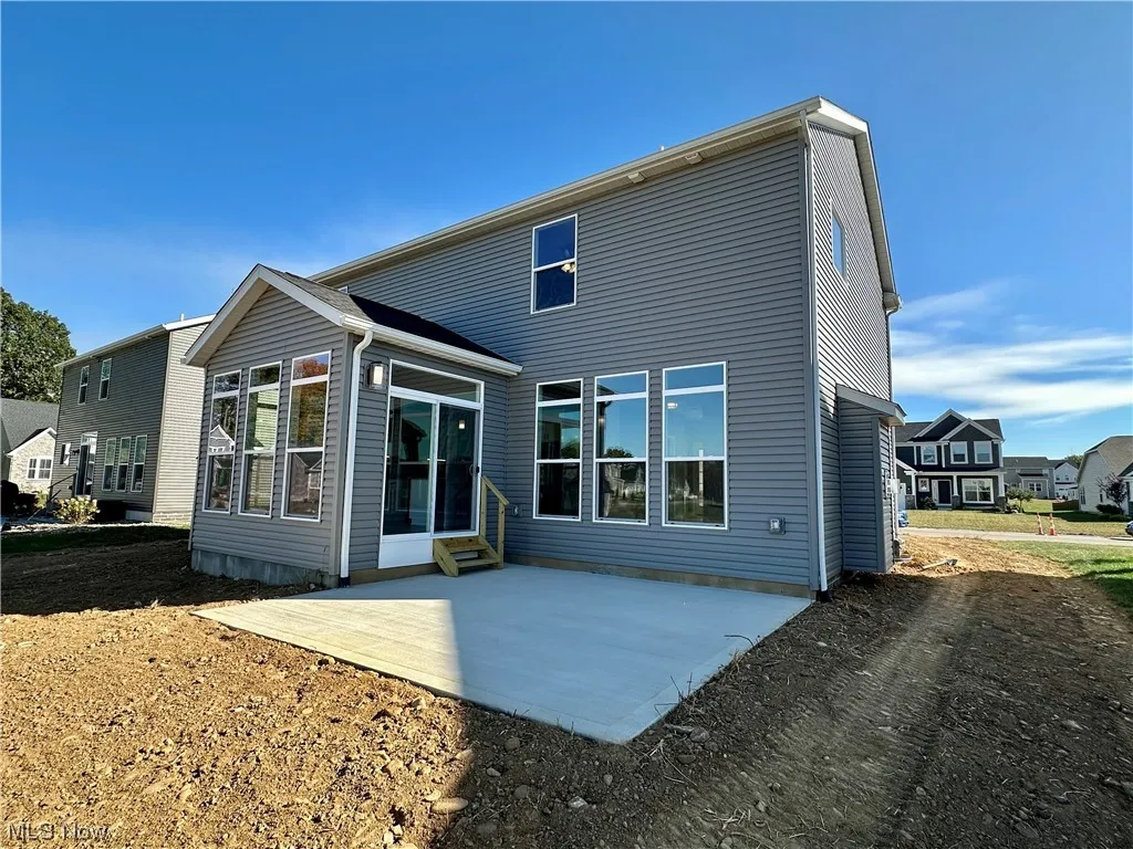 Back of house with a patio