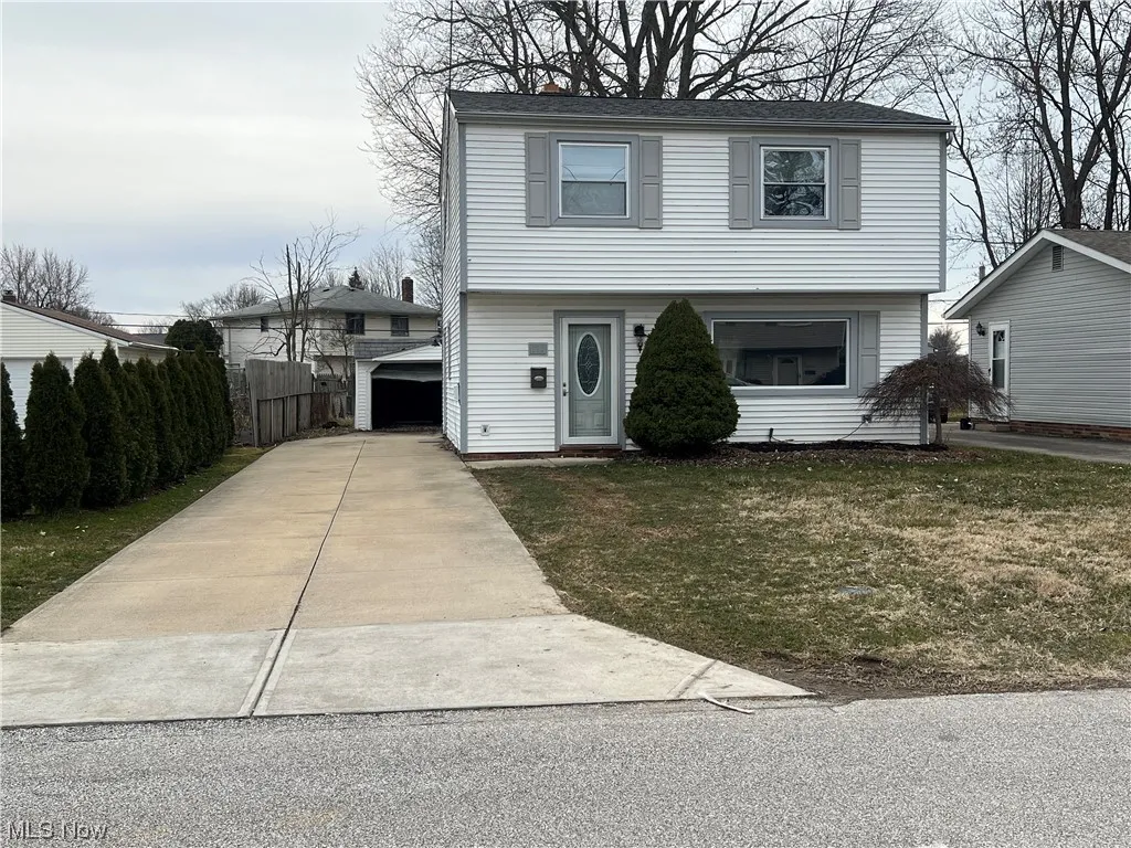 View of property featuring a front lawn
