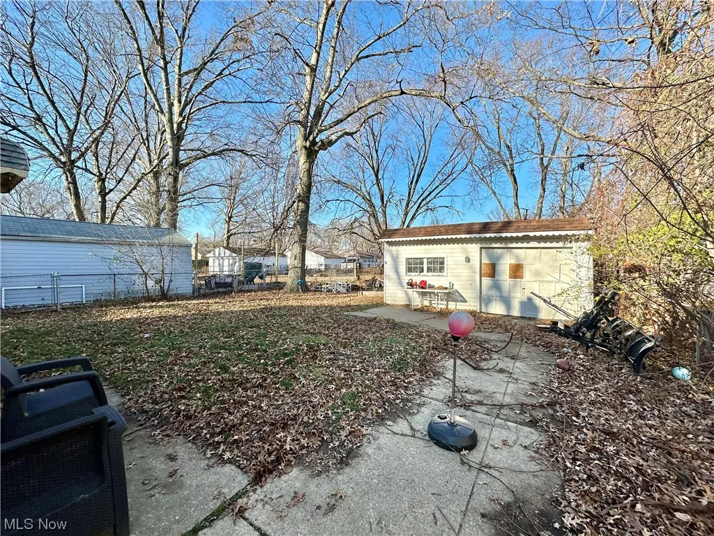 View of yard featuring a patio and a garage