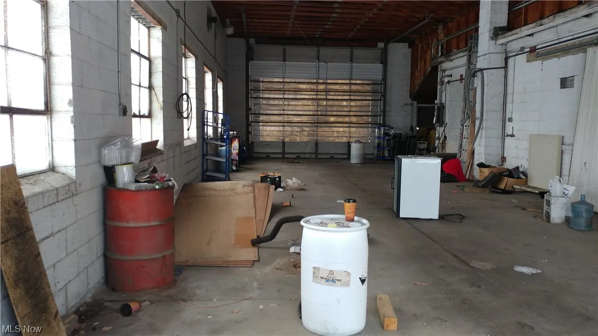 Working door at each end. Yes the space will be eleaned out. $640 a month and $150 cam monthly cam covers your plowing and electric.  Unit has no water or heat amentities in the 1536sq.ft. bay. 
