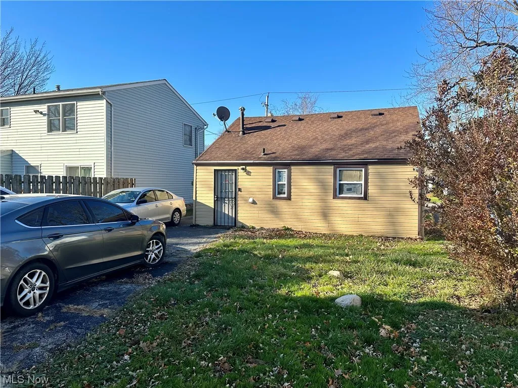 View of side of property featuring a yard