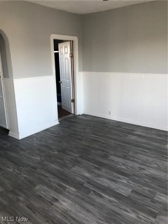 Spare room featuring dark hardwood / wood-style floors