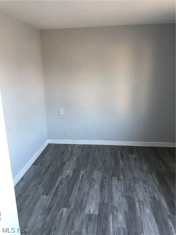 Unfurnished room with dark hardwood / wood-style floors