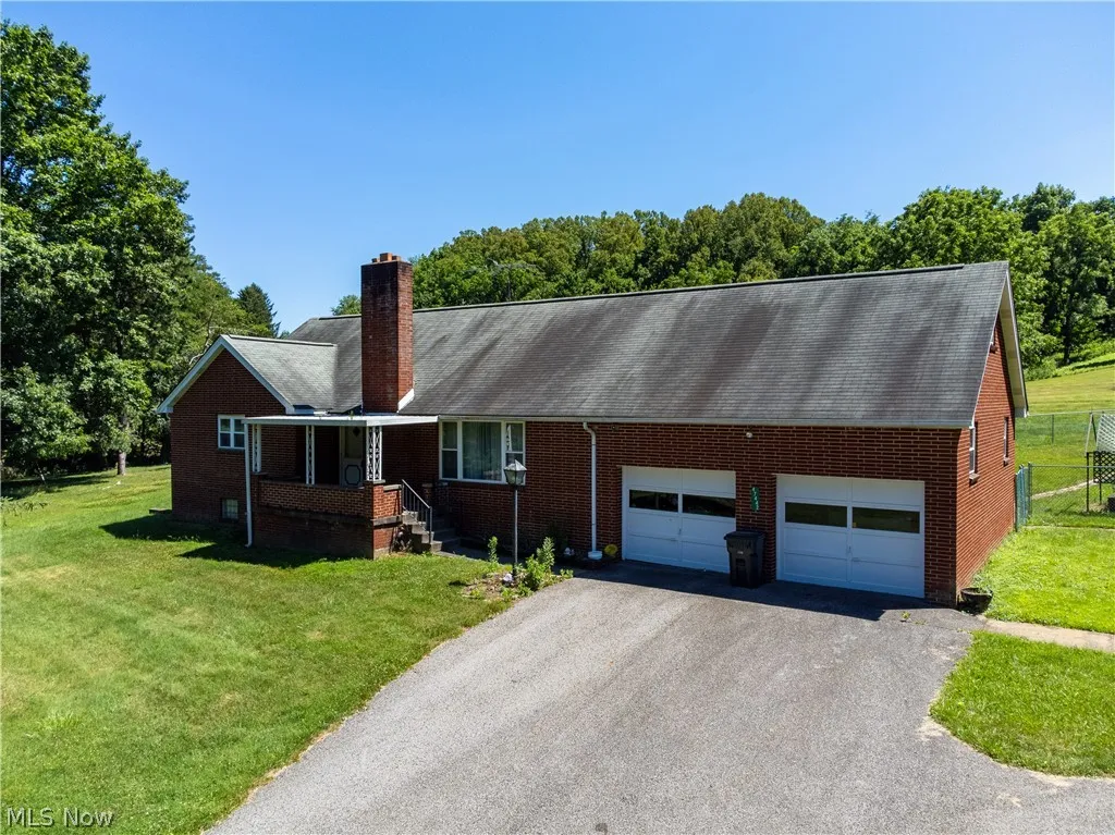 Ranch-style home with a garage and a front yard