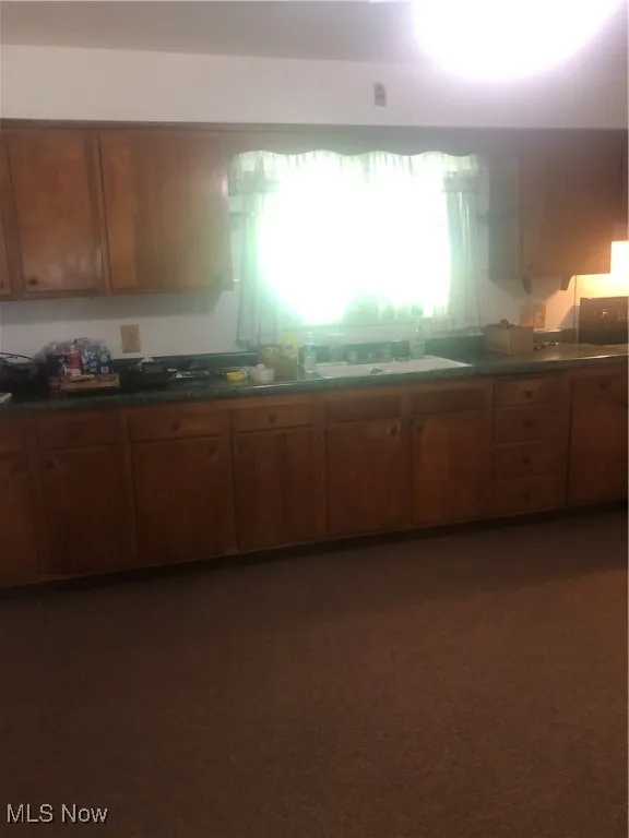 Kitchen with dark countertops