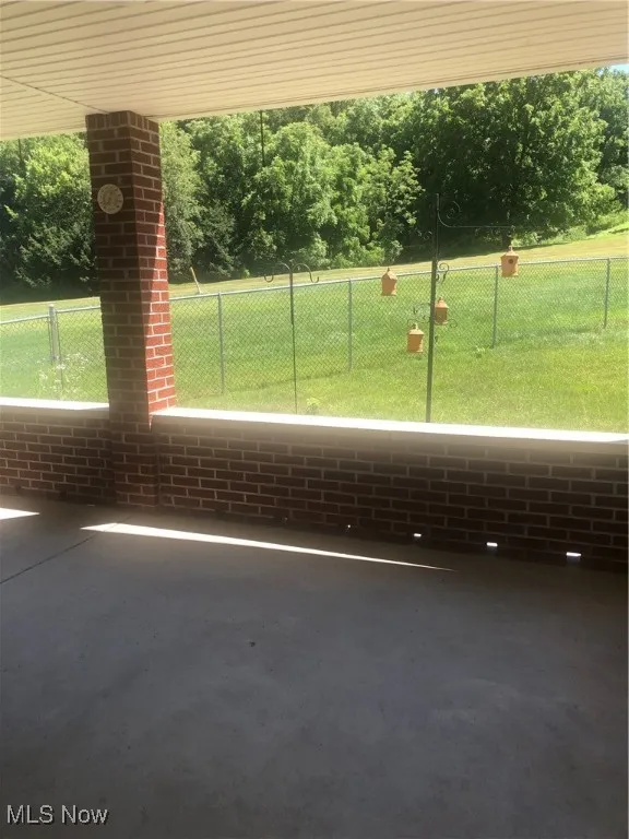 View of property's community with a yard, a patio, and fence