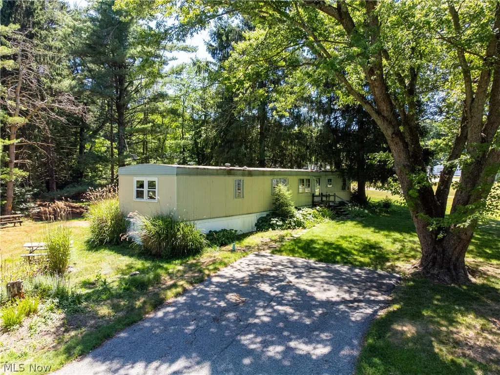View of side of home with a yard
