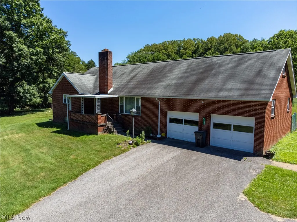 Ranch-style home with a garage and a front lawn