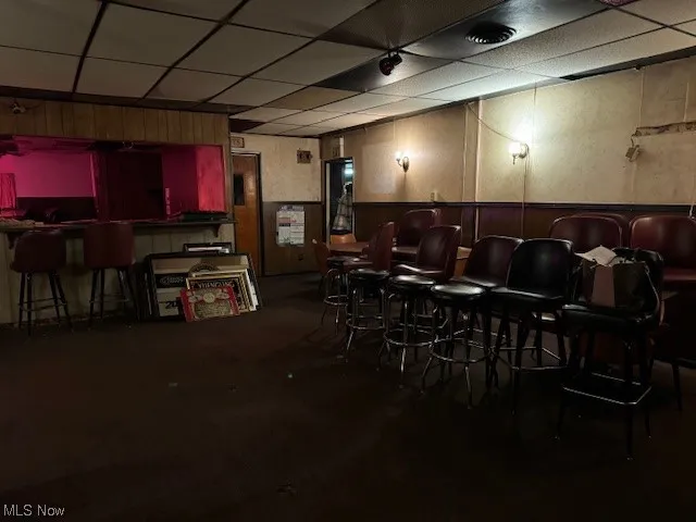 Dining area with bar and a drop ceiling