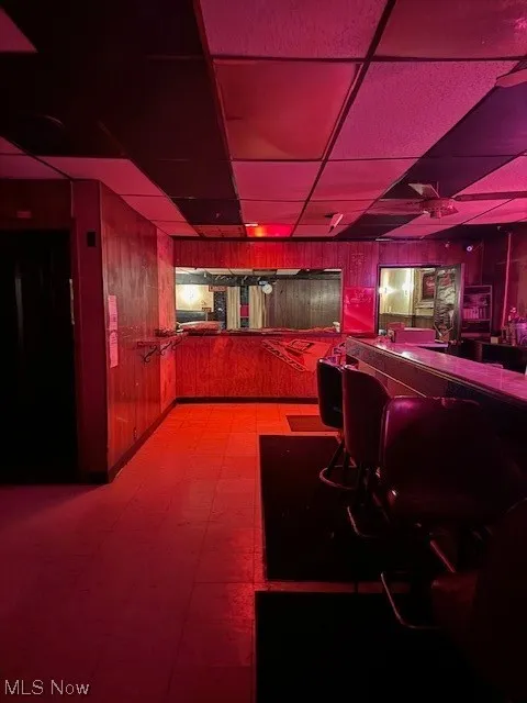Bar featuring a drop ceiling and tile flooring