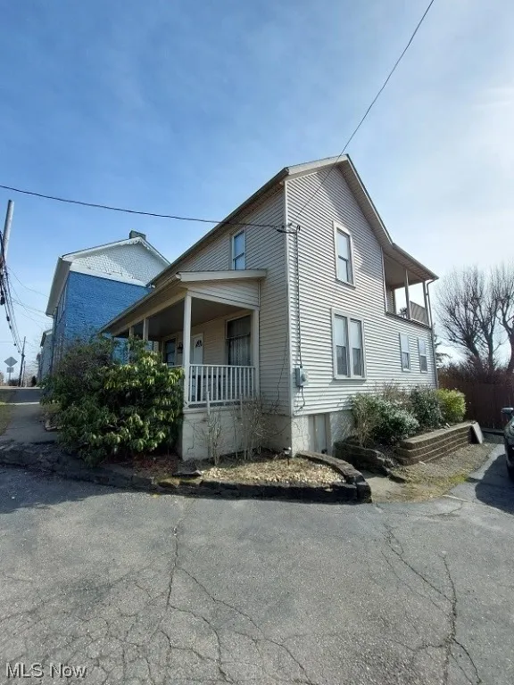 View of property exterior with a porch
