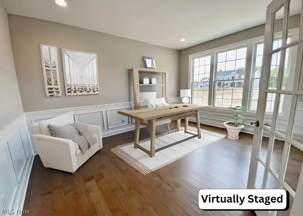 Den/Office with hardwood flooring, wainscotting & glass french doors.