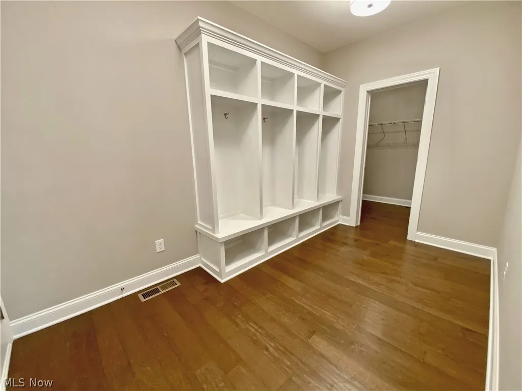 Mudroom featuring cubbies, large walk in closet and Hardwood flooring