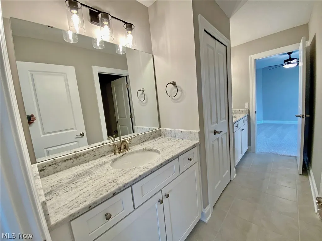 Jack n Jill Bathroom with tile flooring and 2 separate vanities