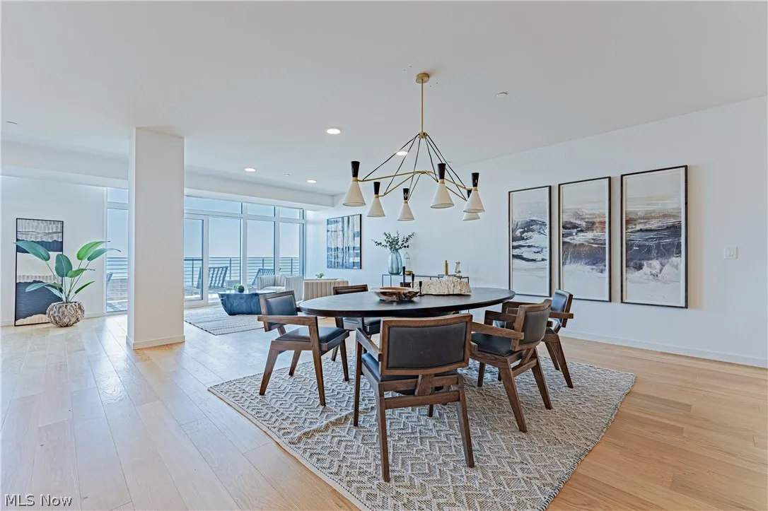 Dining space with a notable chandelier and light hardwood / wood-style flooring