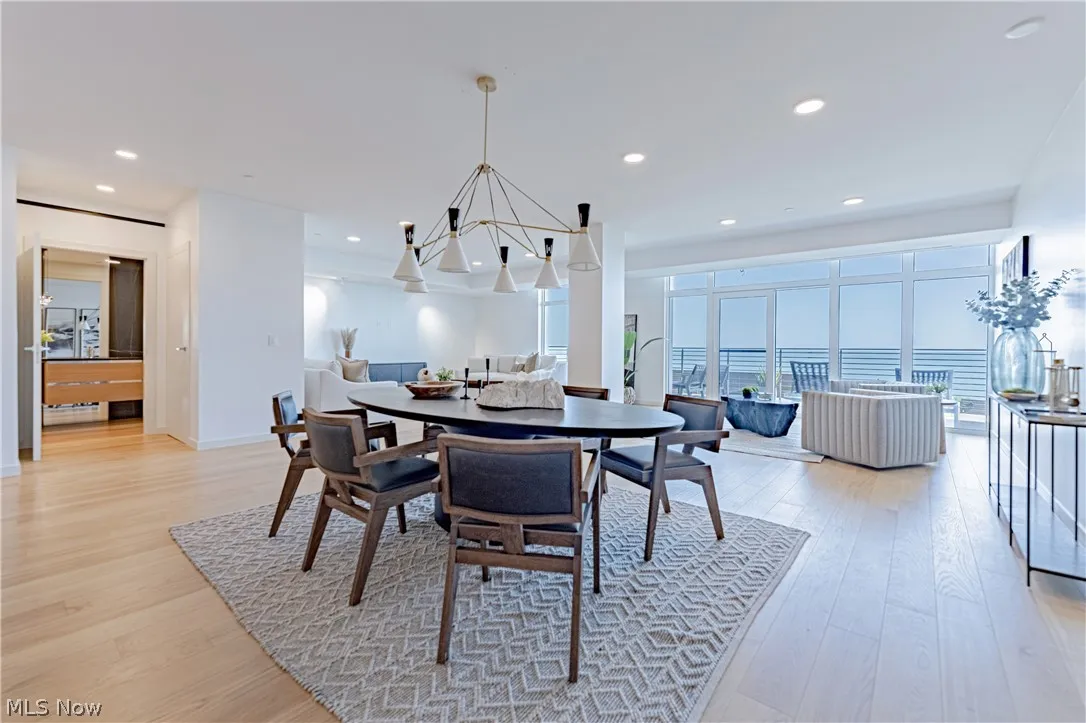 Dining area featuring a water view and light hardwood / wood-style flooring