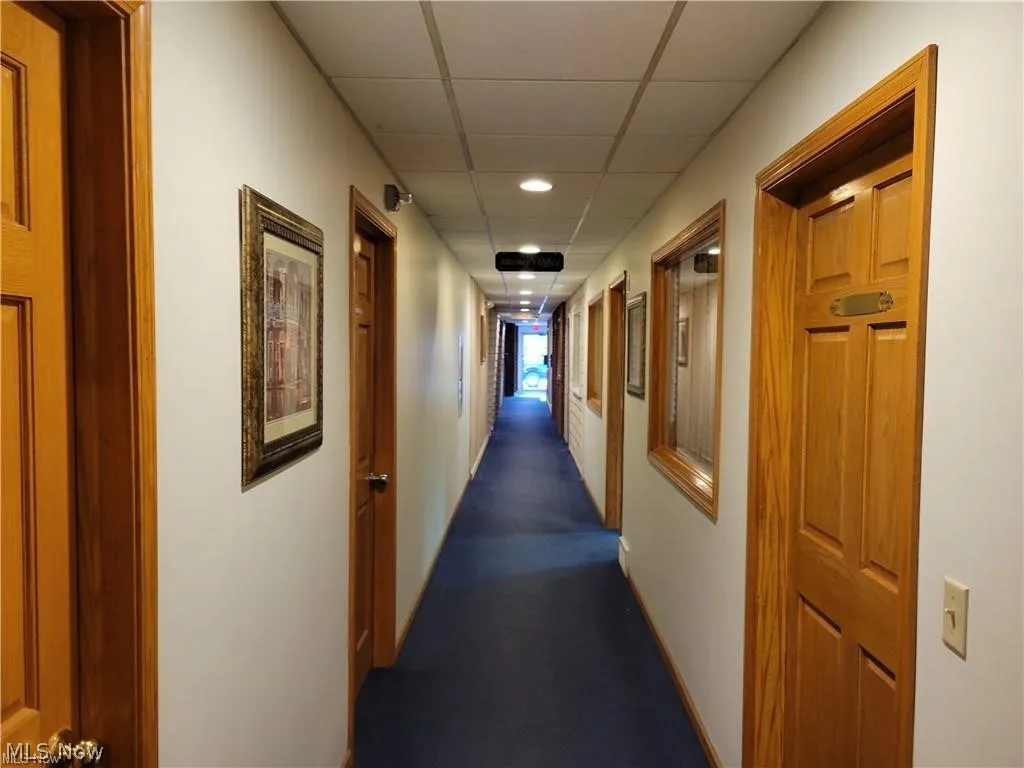Hallway with shared restrooms and kitchenette