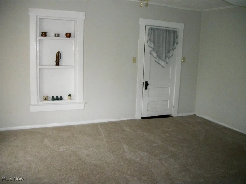 Dining area leading to first floor full bathroom.