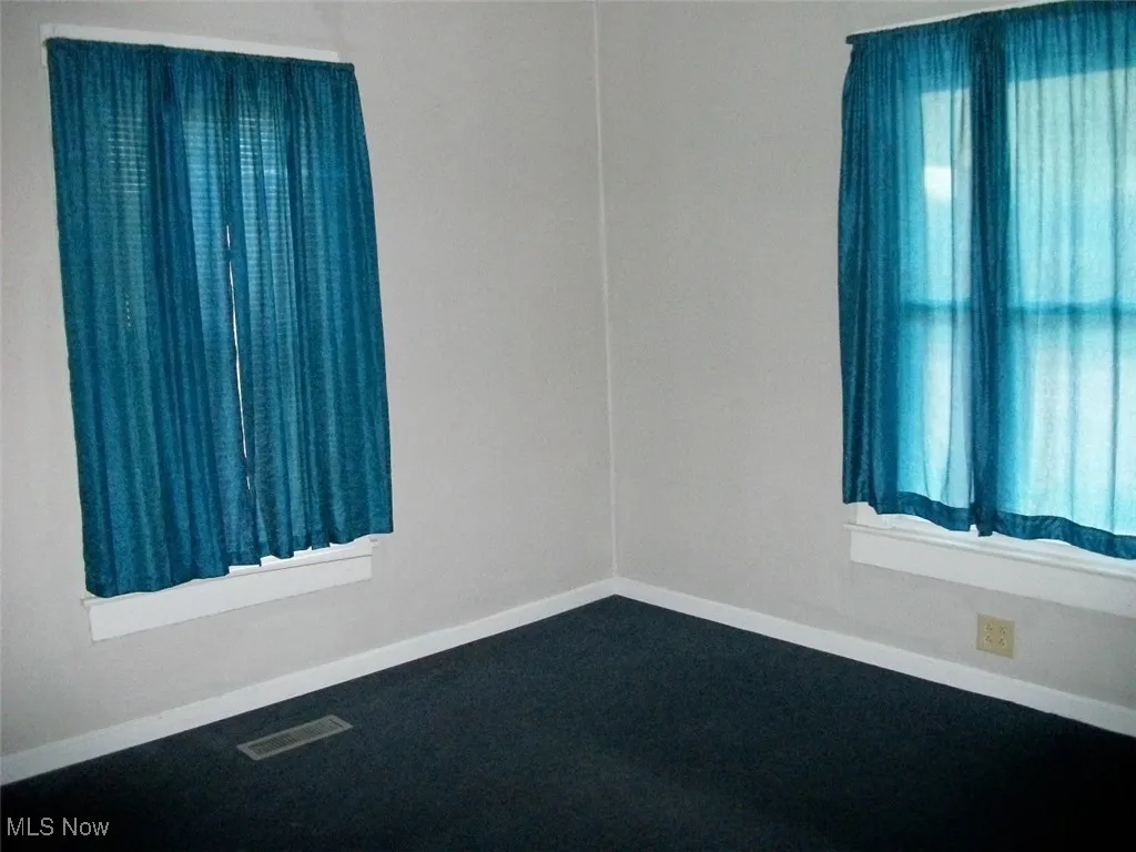 Bonus room featuring baseboards, visible vents, and plenty of natural light