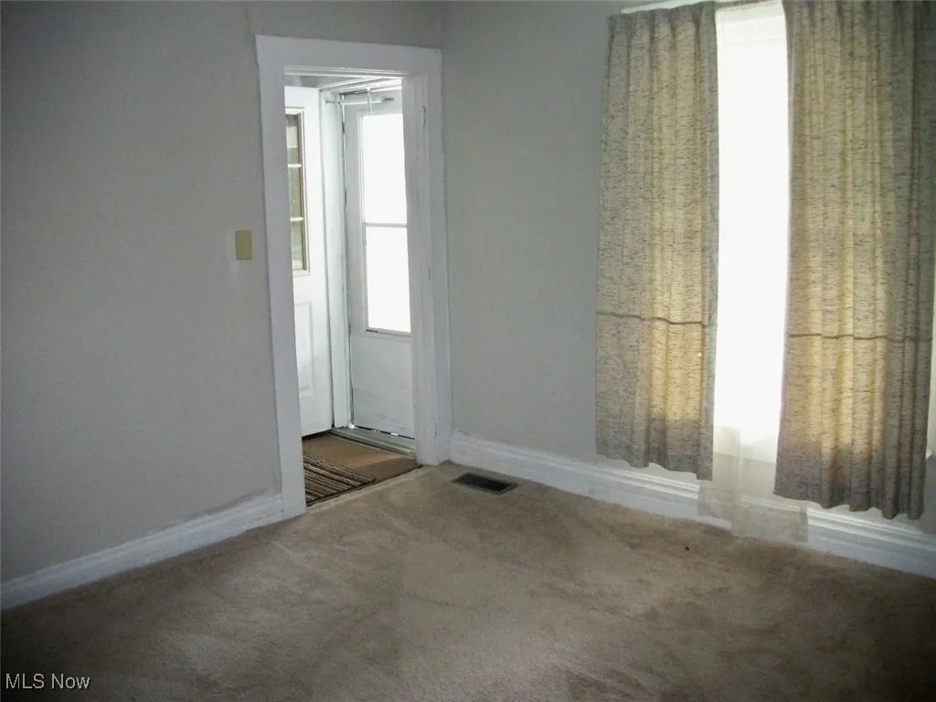  Living room with Neutral carpet leading to upstairs.
