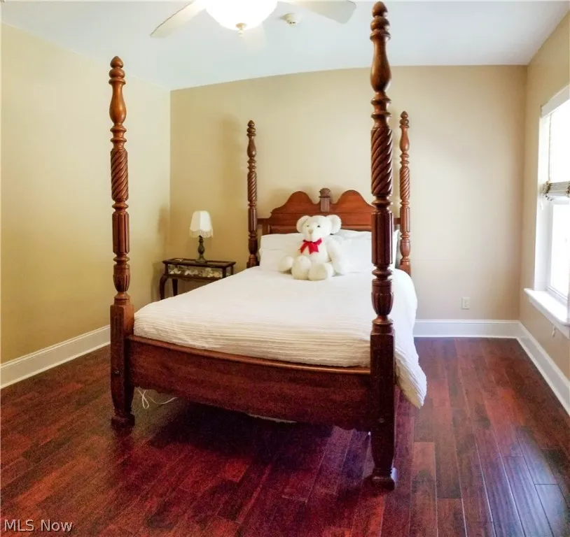 Bedroom featuring dark hardwood / wood-style flooring and ceiling fan