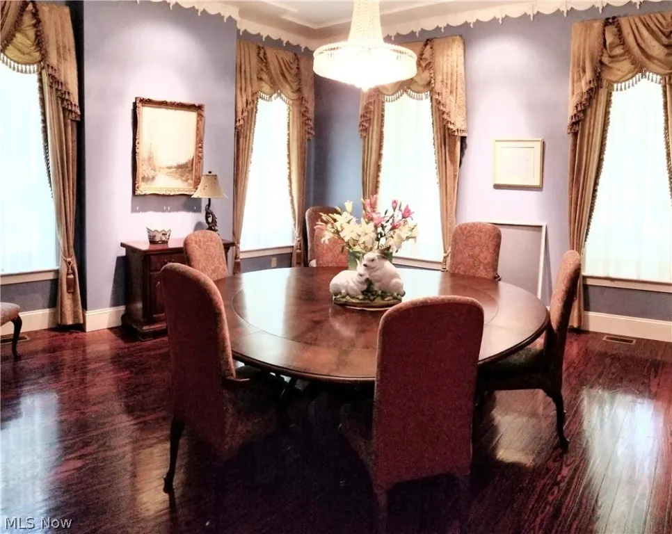 Dining area with dark wood-type flooring