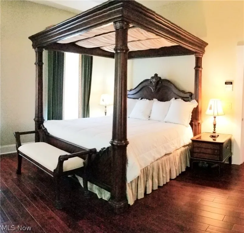 Bedroom with dark hardwood / wood-style floors