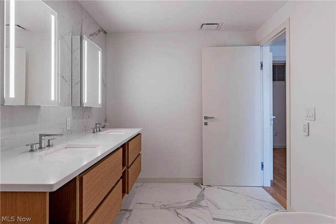 Bathroom featuring tile flooring and double vanity