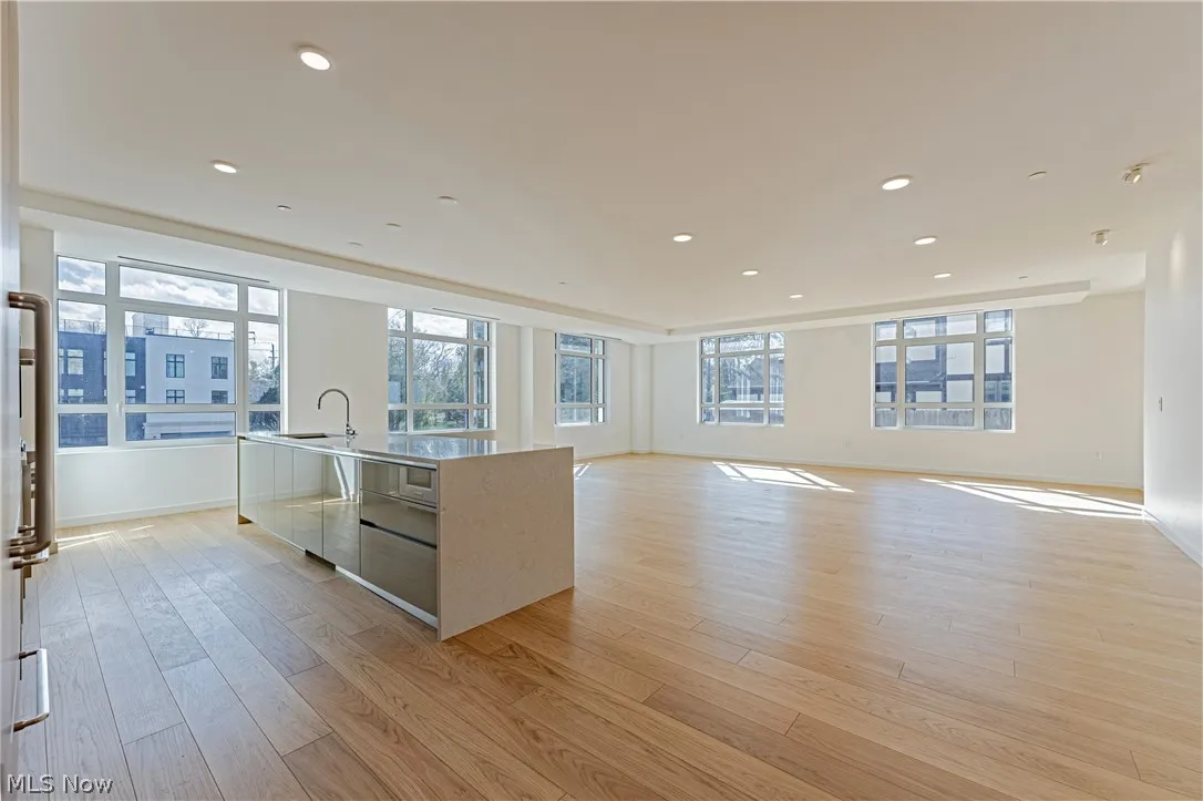 Kitchen with an island with sink and light wood-type flooring