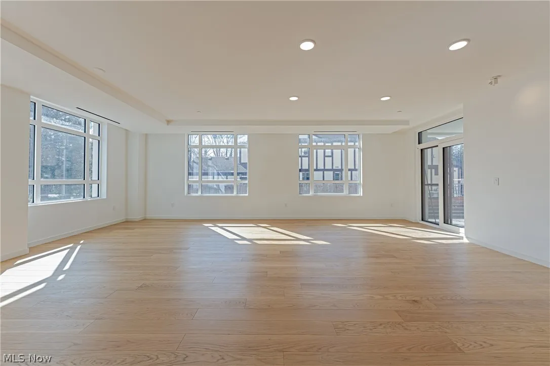 Empty room with light hardwood / wood-style flooring