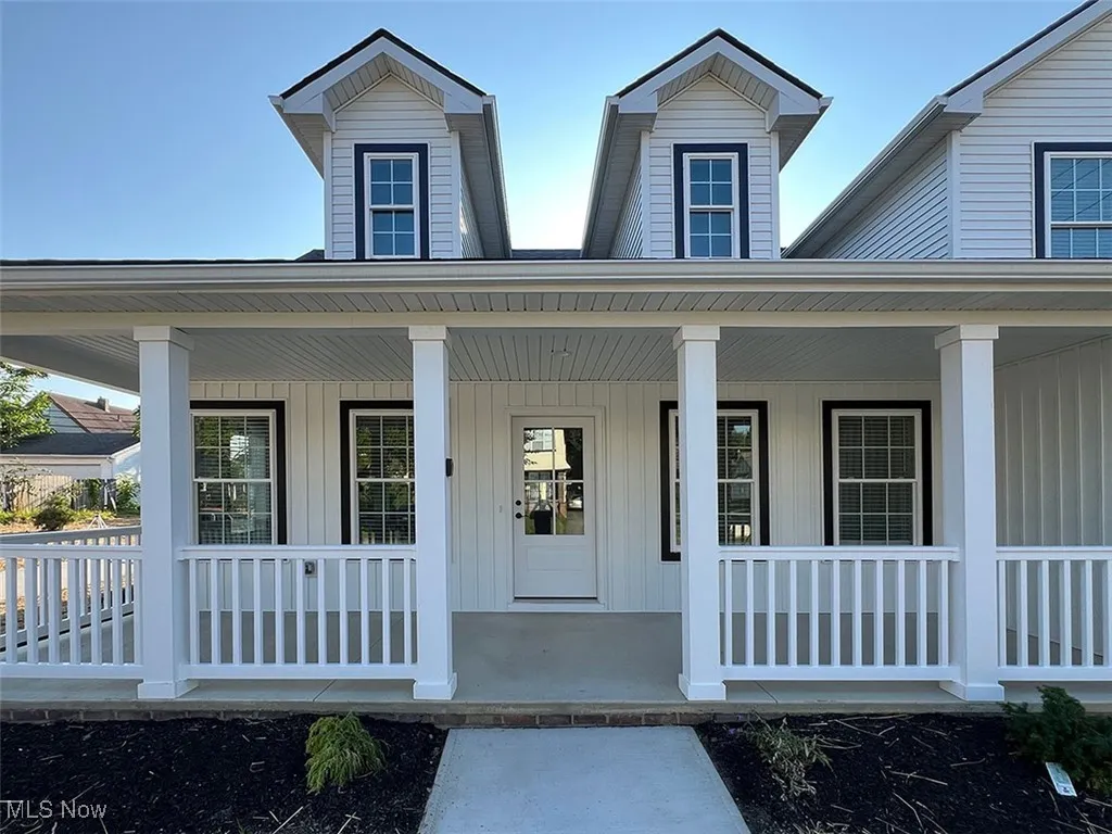 Front doorway to property with covered porch