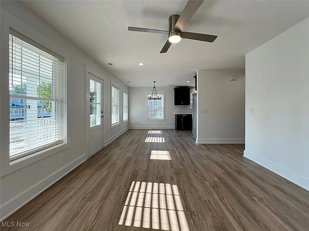 Great Room and dining area room with a chandelier, dark wood finished floors, ceiling fan, and recessed lighting