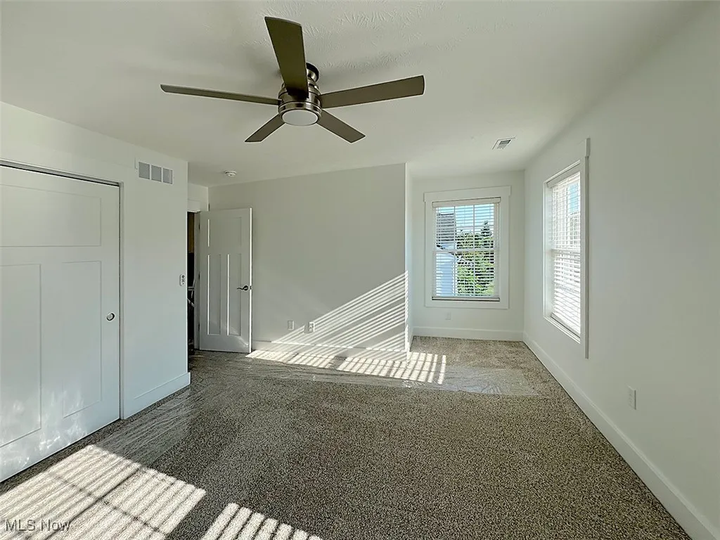Master bedroom with carpet flooring and ceiling fan