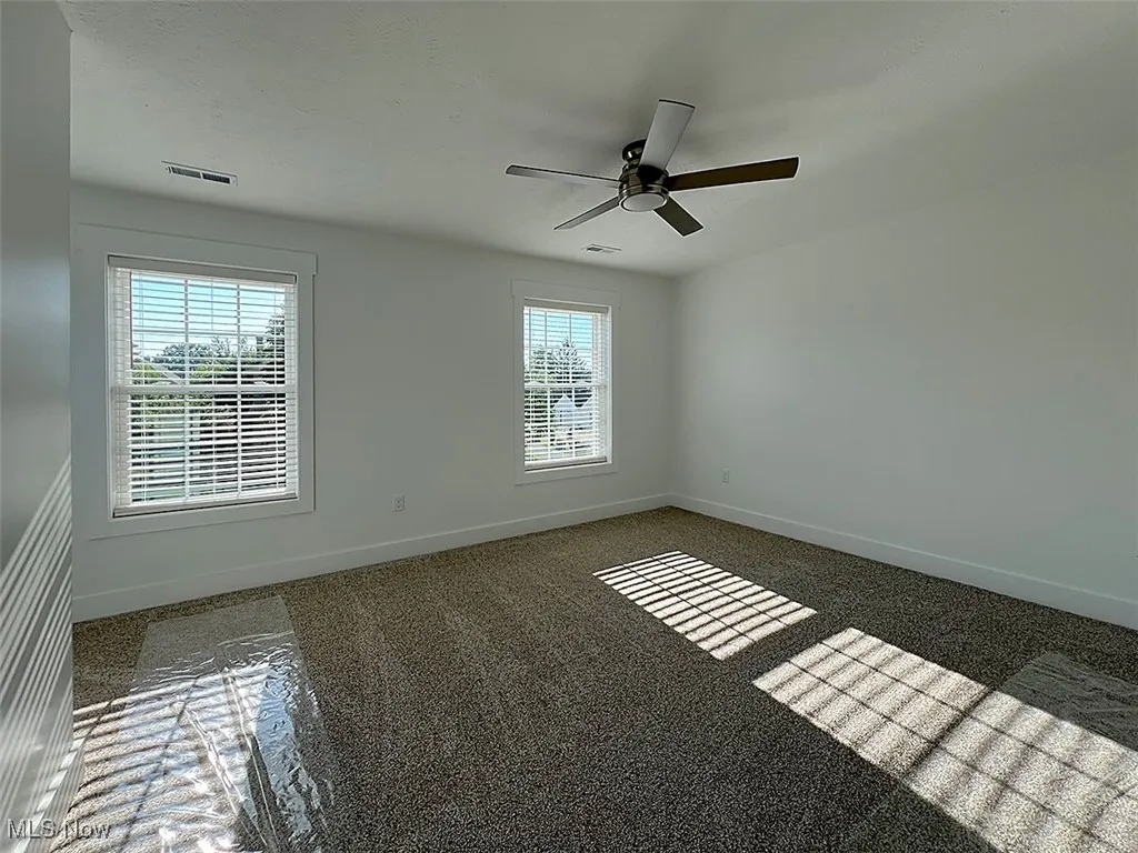 Master bedroom featuring baseboards and a ceiling fan