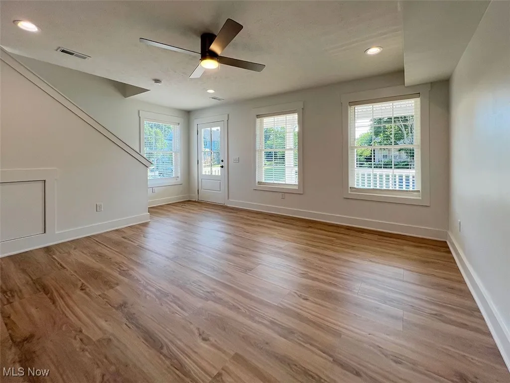 Unfurnished living room with wood finished floors, a ceiling fan, and recessed lighting